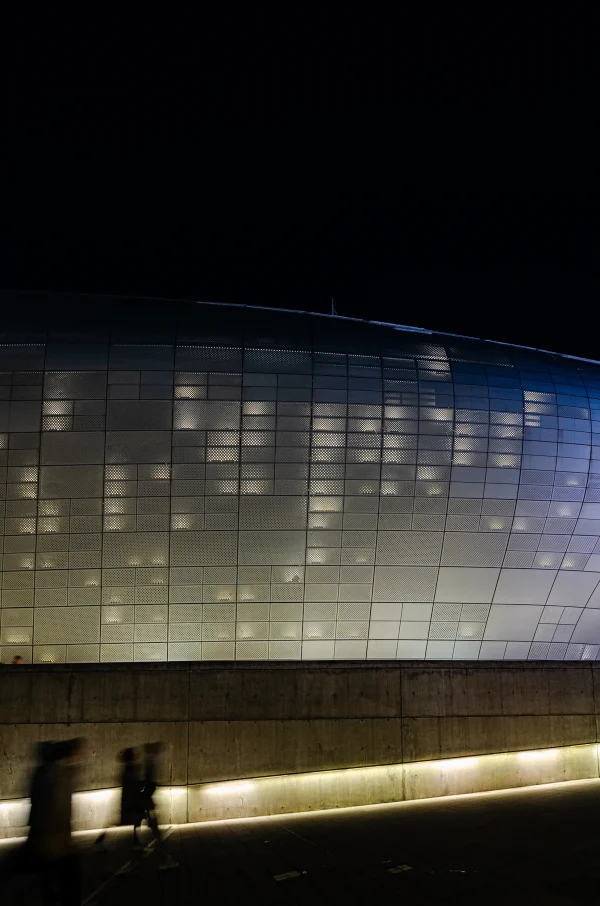 Exterior architectural photography of the Dongdaemun Design Plaza in Seoul at night, designed by Zaha Hadid, photo by Plem Visual Tales.